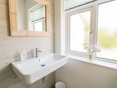 a bathroom with a sink and a window at Senafe in Bude