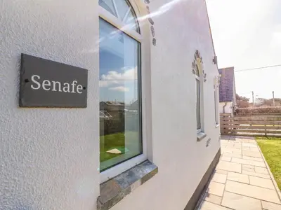 a sign on the side of a building with a window at Senafe in Bude