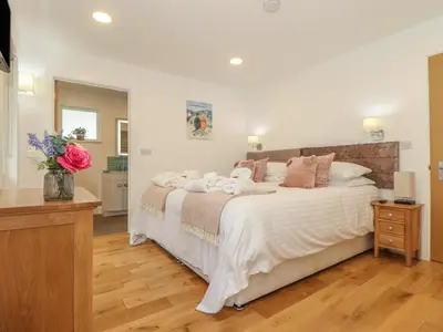 a bedroom with a large bed with towels on it at Hazel in Truro