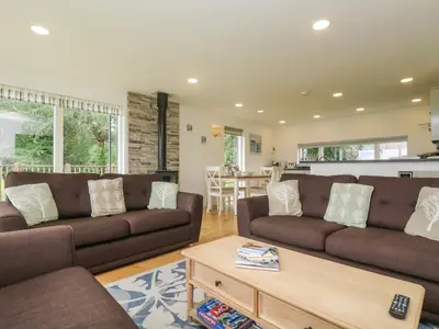 a living room with two brown couches and a table at Hazel in Truro
