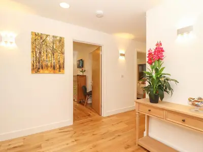 a living room with a painting on the wall at Hazel in Truro