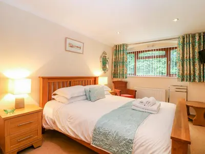 a bedroom with a bed with two towels on it at Lambkin Cottage in Saint Columb Major