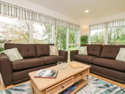 a living room with two brown couches and a coffee table at Elm in Truro