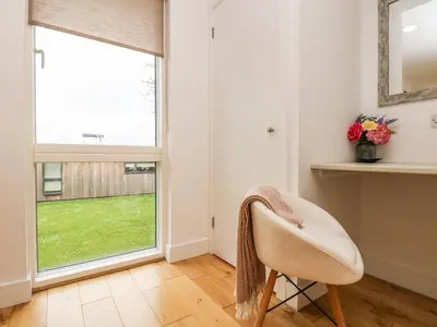 a room with a chair and a window at Elm in Truro