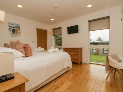 a bedroom with a large bed and a window at Birch in Truro
