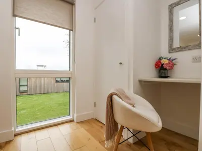 a living room with a chair and a window at Birch in Truro