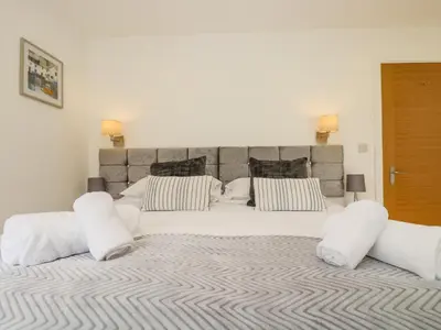 a large white bed with two pillows on it at Birch in Truro