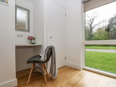 a chair in a room with a window at Birch in Truro