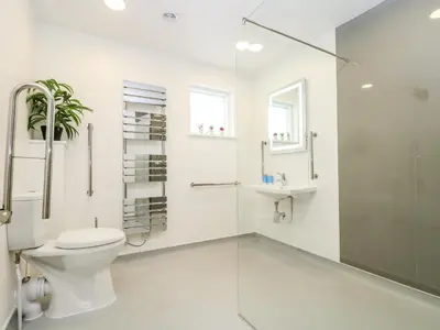 a bathroom with a toilet and a glass shower at Beech in Truro