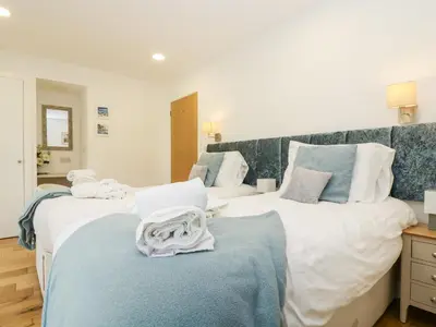 a bedroom with two beds with towels on them at Beech in Truro