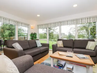 a living room with two couches and a table at Beech in Truro