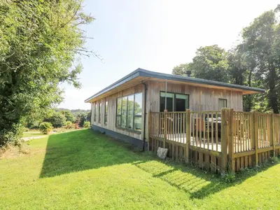 a wooden house with a fence in a yard at Ash in Truro
