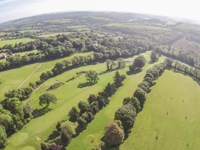 an aerial view of a green field with trees at Ash in Truro