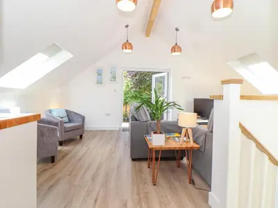a living room with a couch and a table at The Crest in Helston