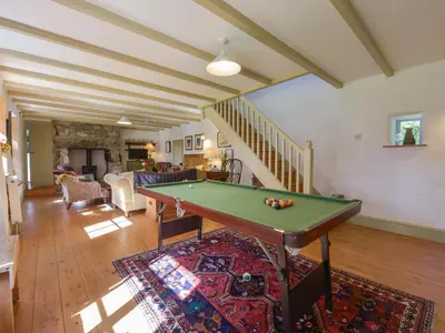 a living room with a pool table in it at Heather Cottage in Penzance
