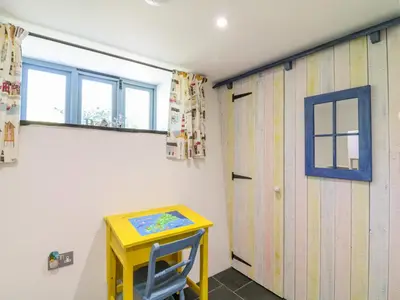 a yellow table and a yellow door in a room at Manor House Barn in Camelford
