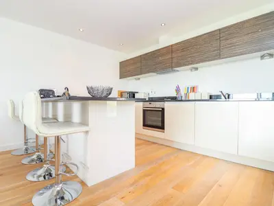 a kitchen with white cabinets and a counter top at 8 Cribbar in Newquay