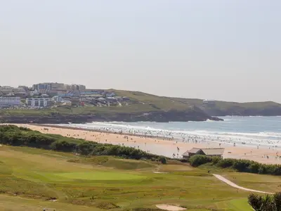 a group of people on a beach and the ocean at 8 Cribbar in Newquay
