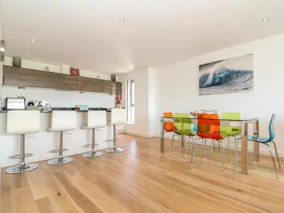 a kitchen and dining room with a table and chairs at 8 Cribbar in Newquay