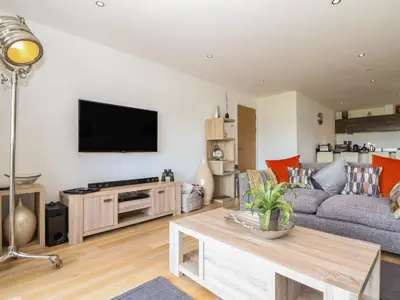 a living room with a couch and a tv at 8 Cribbar in Newquay