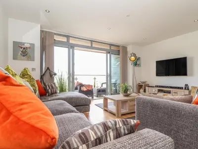 a living room with two couches and a tv at 8 Cribbar in Newquay