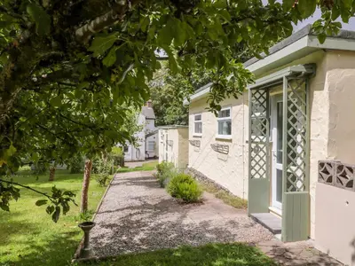 a house with a green door and a yard at The Roost in Camborne