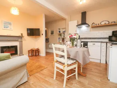 a kitchen with a table with a vase of flowers on it at The Roost in Camborne