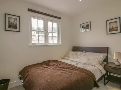 a bedroom with a bed and a window at Cherrywood Manor in Bodmin
