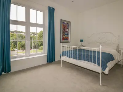 a bedroom with a bed and a large window at Cherrywood Manor in Bodmin