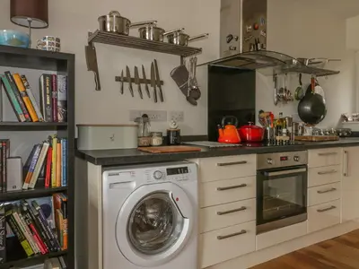 a kitchen with a washer and a washing machine at Cherrywood Manor in Bodmin