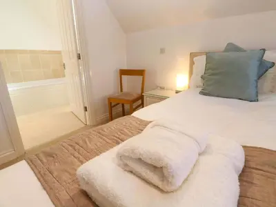 a bedroom with a bed with white towels on it at Meridian in St Ives