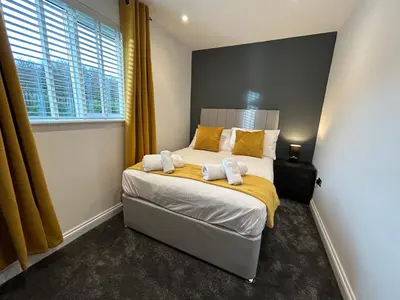 a bedroom with a bed with two towels on it at Willow, Retallack in Saint Columb Major