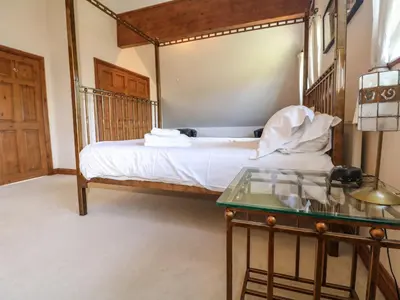 a bedroom with a bed and a glass table at Willow, Retallack in Saint Columb Major