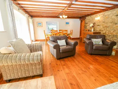 a living room with two couches and a table at Coth Skyber in Hayle