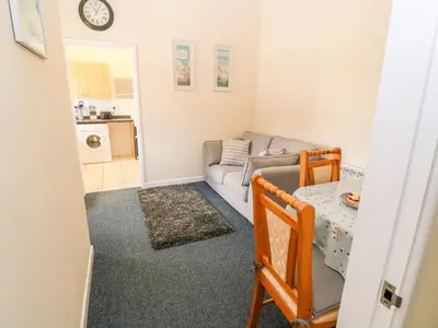 a living room with a couch and a table at The Old Cows House in Helston