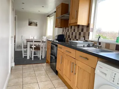 a kitchen with a sink and a stove top oven at Copthorne - Tintagel in Tintagel