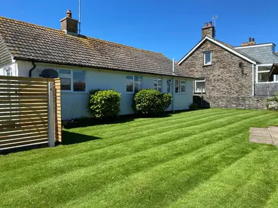 a house with a large lawn in front of it at Copthorne - Tintagel in Tintagel