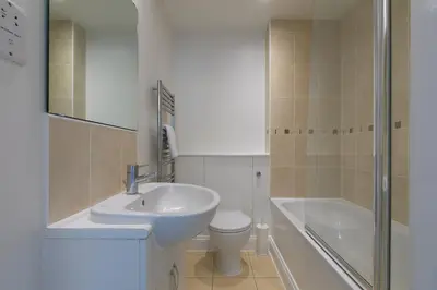 a bathroom with a sink and a toilet and a shower at Honeysuckle Cottage, Lelant in Uny Lelant