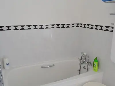 a bathroom with a sink and a bath tub at Roadstead in Fowey