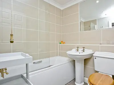 a bathroom with a sink and a toilet and a bath tub at Chyandour in Fowey
