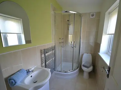 a bathroom with a shower and a sink and a toilet at Riverview in Fowey