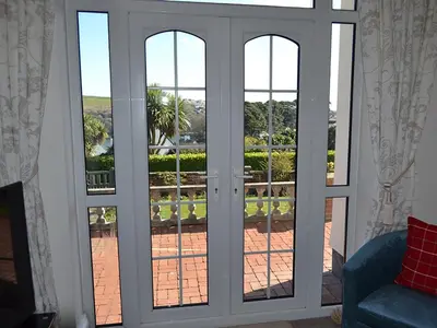 a glass door with a view of a patio at Riverview in Fowey