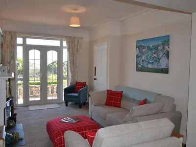 a living room with a couch and a chair at Riverview in Fowey