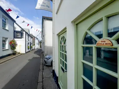 a street with a sign on the side of a building at Lower Deck in Fowey