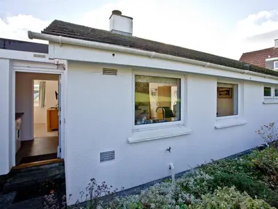 a white house with a window on the side of it at The Lodge in Fowey