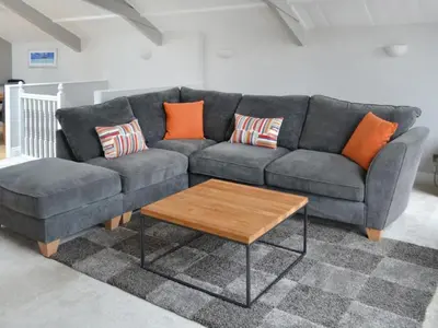 a living room with a couch and a coffee table at St Monicas in Fowey