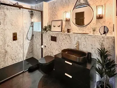 a bathroom with a sink and a toilet and a shower at Rosie Cottage in Fowey