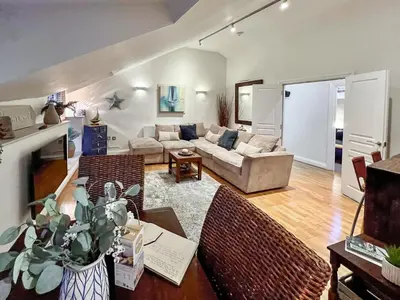 a living room with a couch and a table at Rosie Cottage in Fowey