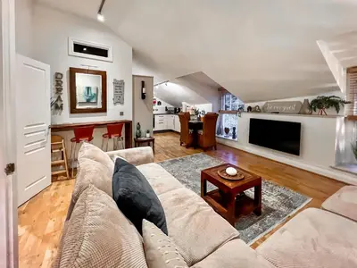 a living room with a couch and a table at Rosie Cottage in Fowey