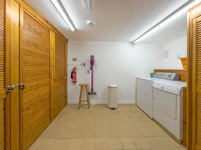 a kitchen with a wooden door and a stove at Middle Deck in Fowey